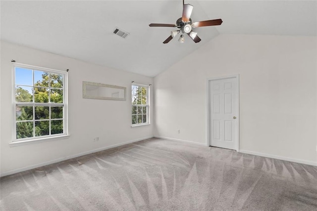 carpeted empty room with lofted ceiling, visible vents, ceiling fan, and baseboards