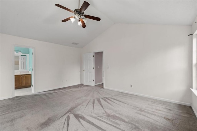 interior space with high vaulted ceiling, carpet flooring, a ceiling fan, baseboards, and ensuite bath