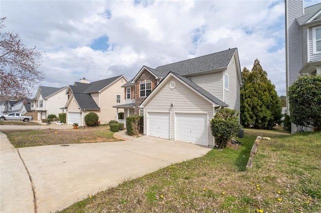 traditional-style home with a garage, driveway, a front yard, and a residential view