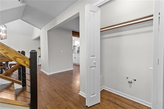 interior space with a chandelier, baseboards, and wood finished floors