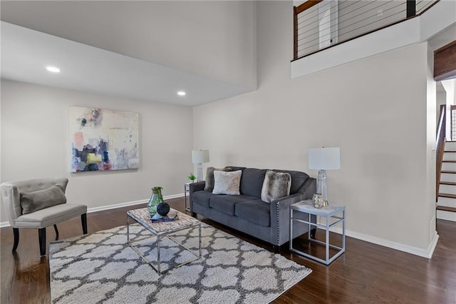 living room featuring stairway, recessed lighting, wood finished floors, and baseboards