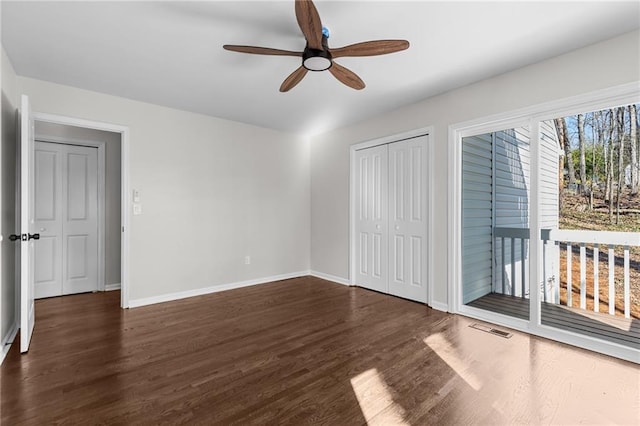 unfurnished bedroom with visible vents, a ceiling fan, baseboards, and wood finished floors