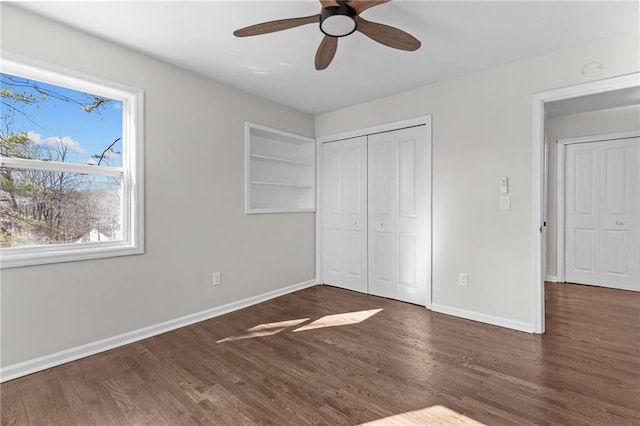 unfurnished bedroom with a closet, a ceiling fan, baseboards, and wood finished floors