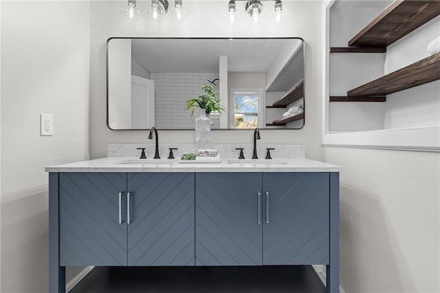 full bath featuring double vanity and a sink