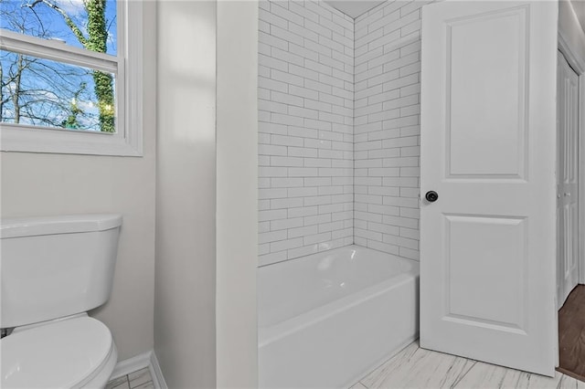 full bathroom with toilet and baseboards