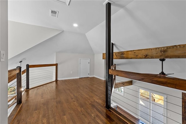 additional living space featuring visible vents, baseboards, lofted ceiling, wood finished floors, and a ceiling fan