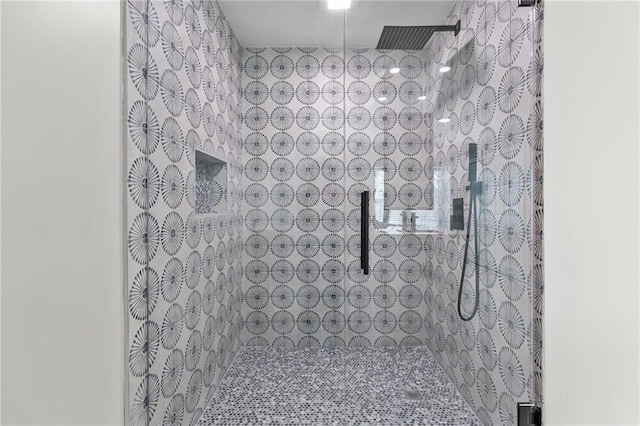 bathroom with a tile shower