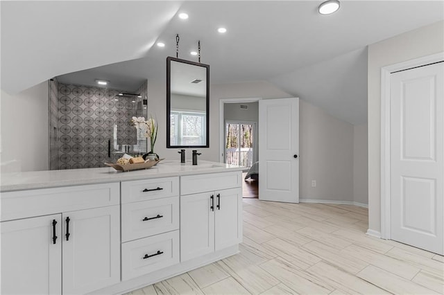 bar with lofted ceiling, recessed lighting, baseboards, and a sink