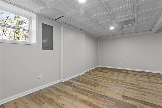 below grade area with electric panel, baseboards, and an ornate ceiling