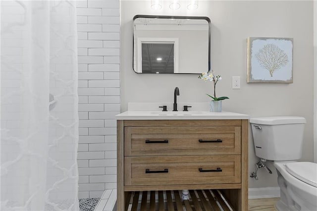 full bathroom featuring toilet, vanity, and a tile shower