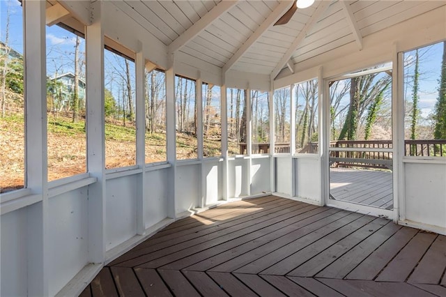 unfurnished sunroom featuring wood ceiling and lofted ceiling with beams