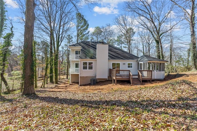 back of property featuring central AC unit, a sunroom, and a wooden deck