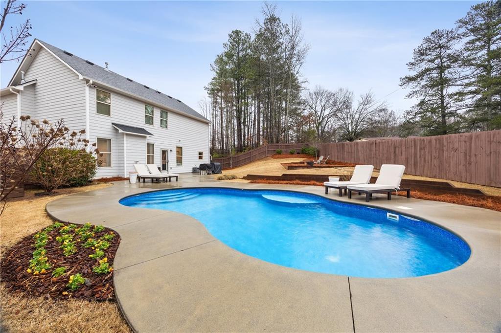 view of pool with a fenced backyard, a fenced in pool, and a patio