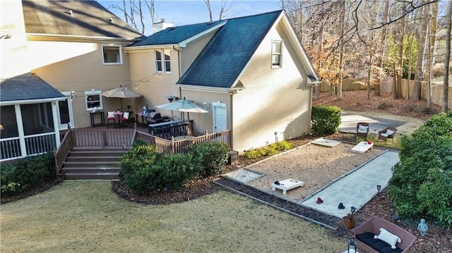 rear view of property with a wooden deck