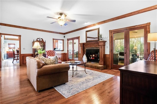 living room with crown molding, hardwood / wood-style flooring, french doors, and ceiling fan