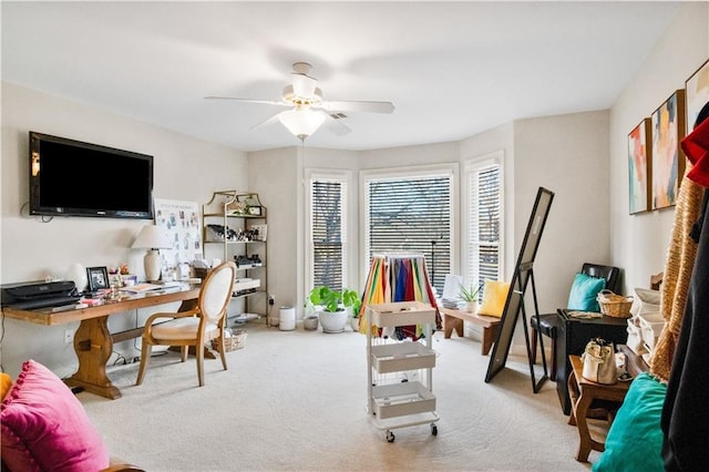 carpeted home office with ceiling fan