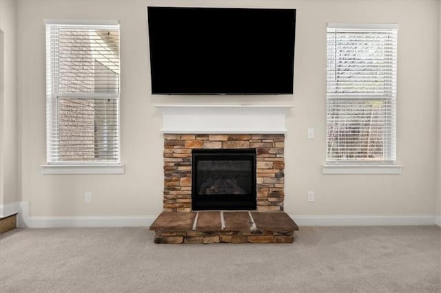 interior details with baseboards, carpet flooring, and a fireplace