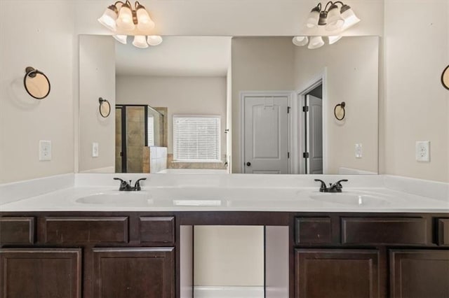 full bathroom featuring double vanity, a sink, and a stall shower
