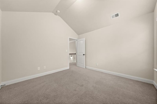 unfurnished bedroom with visible vents, baseboards, carpet floors, and lofted ceiling