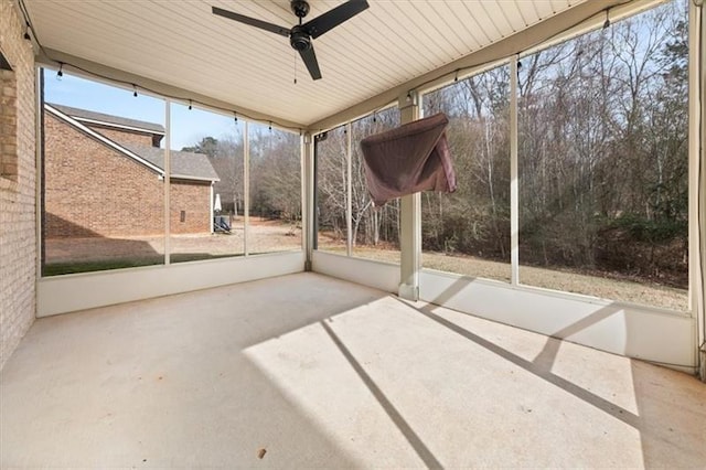 unfurnished sunroom with ceiling fan