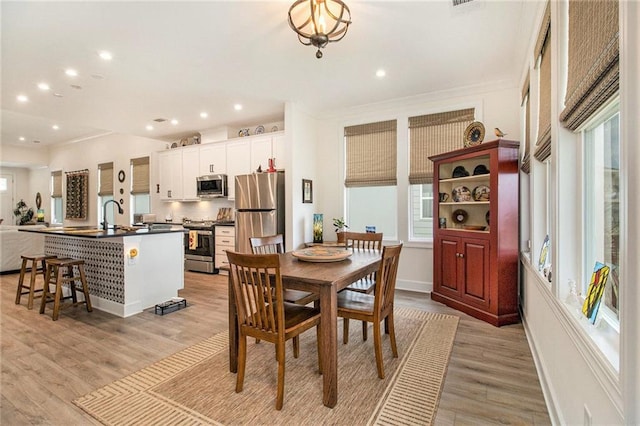 dining room featuring plenty of natural light, recessed lighting, and light wood-style floors