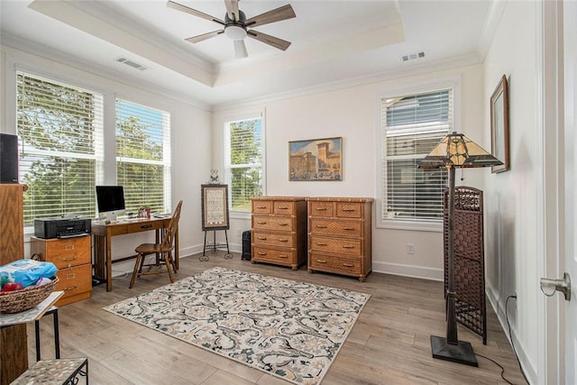 office space featuring visible vents, a raised ceiling, and crown molding