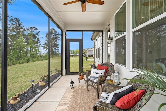 sunroom / solarium featuring ceiling fan