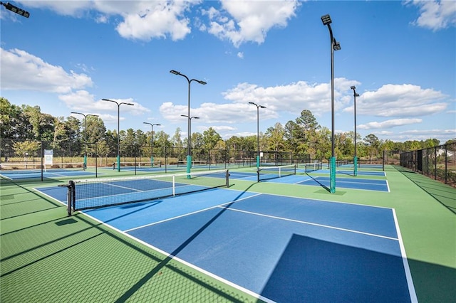view of tennis court featuring fence