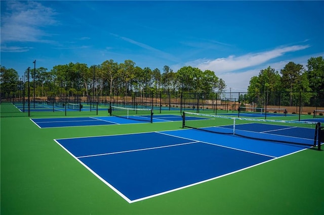 view of tennis court featuring fence and community basketball court