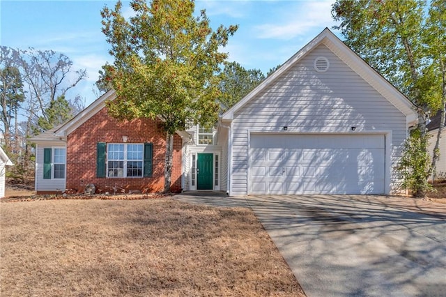 single story home featuring concrete driveway, brick siding, and an attached garage