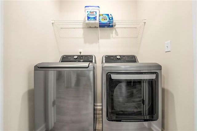 clothes washing area featuring washer and dryer