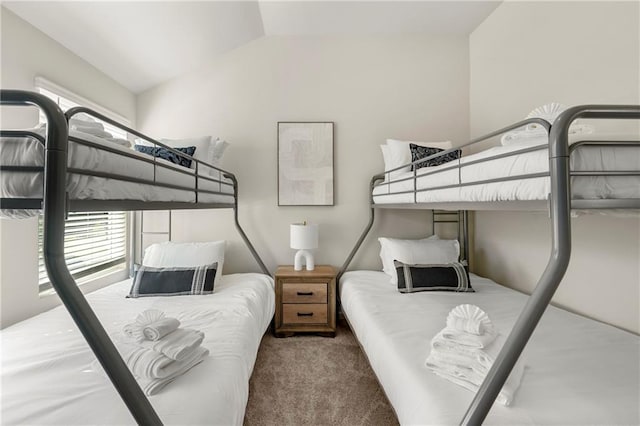 carpeted bedroom featuring lofted ceiling