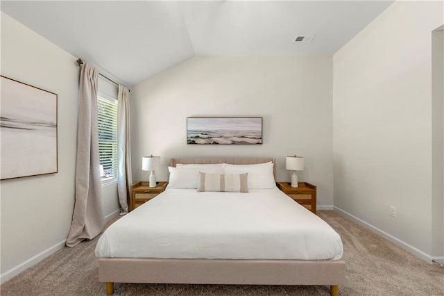 bedroom featuring vaulted ceiling and light colored carpet