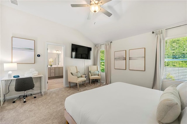 carpeted bedroom with ceiling fan, ensuite bathroom, and lofted ceiling