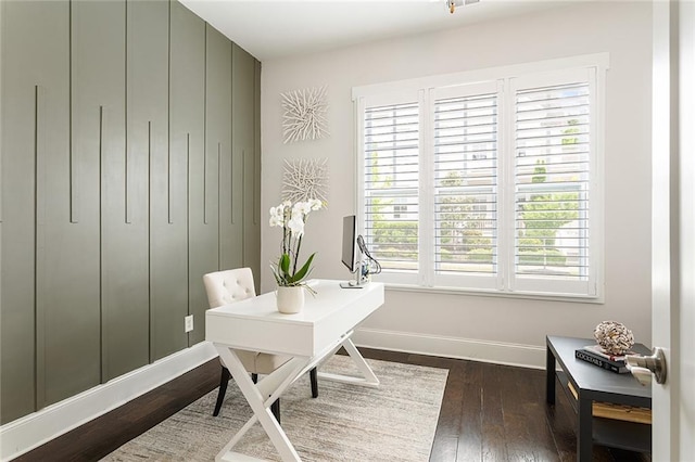 office area with baseboards and dark wood-type flooring