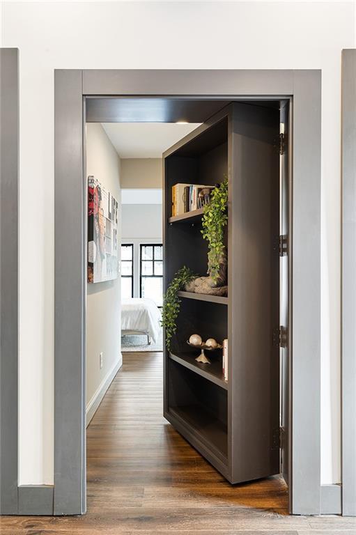 hallway with baseboards and dark wood finished floors