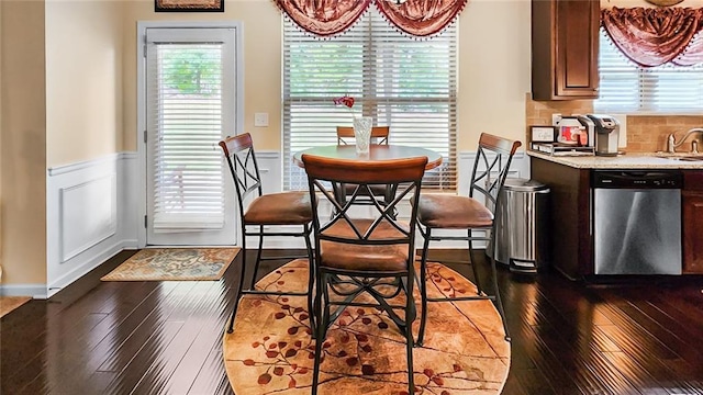 dining area with sink and dark hardwood / wood-style flooring