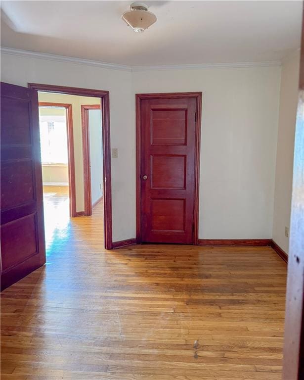 unfurnished room featuring crown molding and light hardwood / wood-style flooring