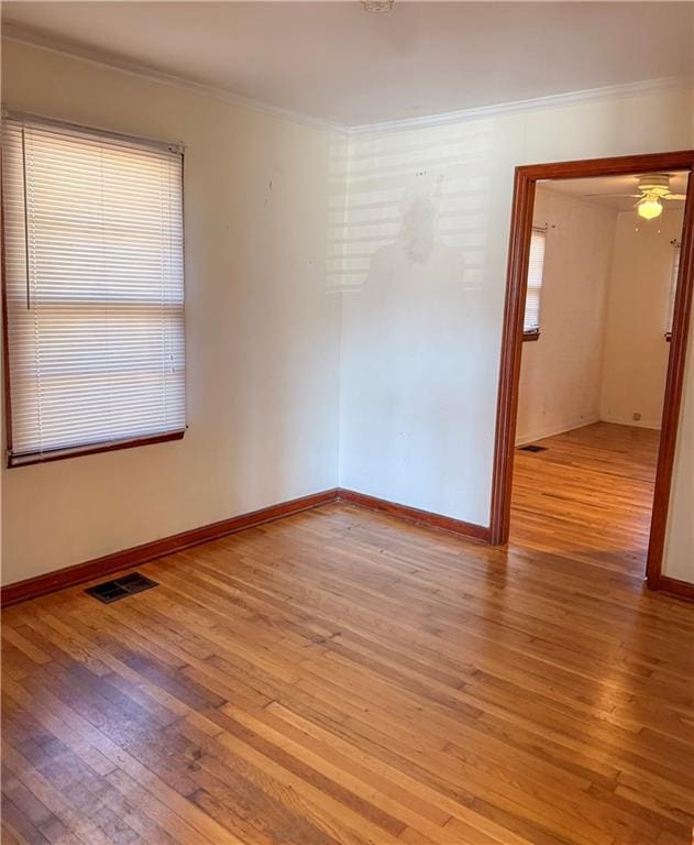 unfurnished room with ceiling fan, light hardwood / wood-style floors, and ornamental molding