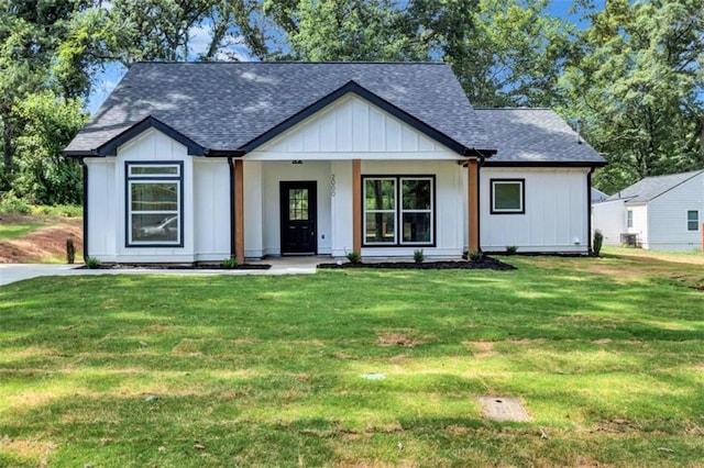 modern farmhouse style home featuring a front yard and covered porch