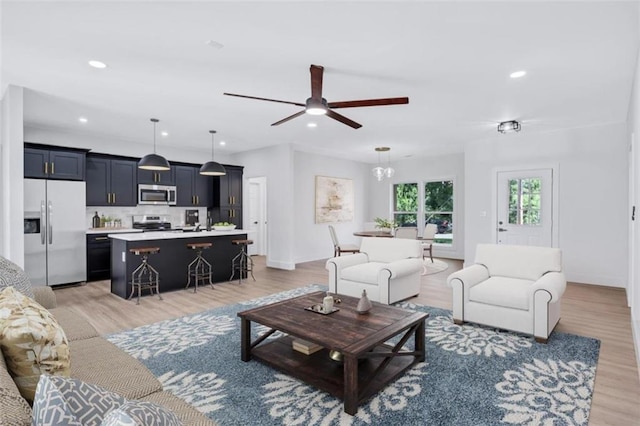 living room with ceiling fan and hardwood / wood-style floors