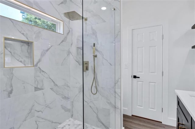 bathroom with vanity, a shower with door, and hardwood / wood-style floors