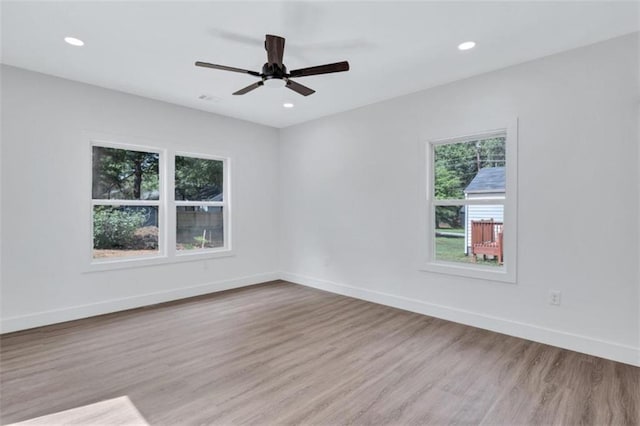 spare room with light hardwood / wood-style floors and ceiling fan