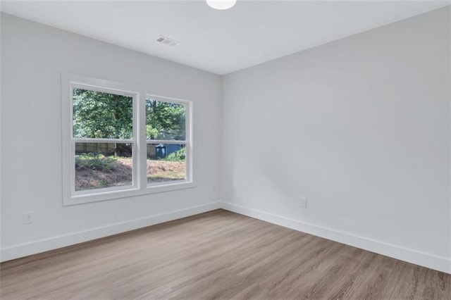 spare room with light hardwood / wood-style floors