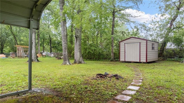view of grassy yard with a storage shed and an outbuilding