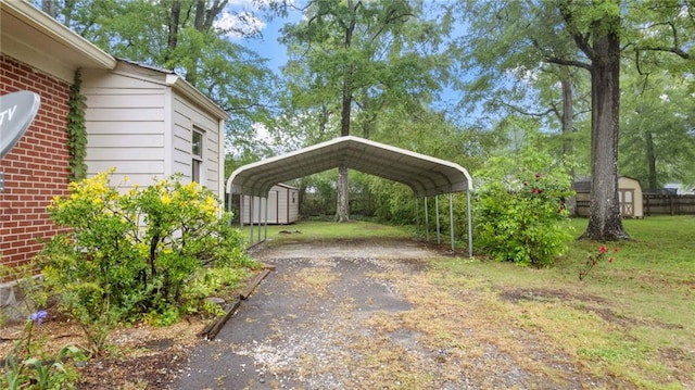 view of vehicle parking featuring a storage unit, a detached carport, and asphalt driveway
