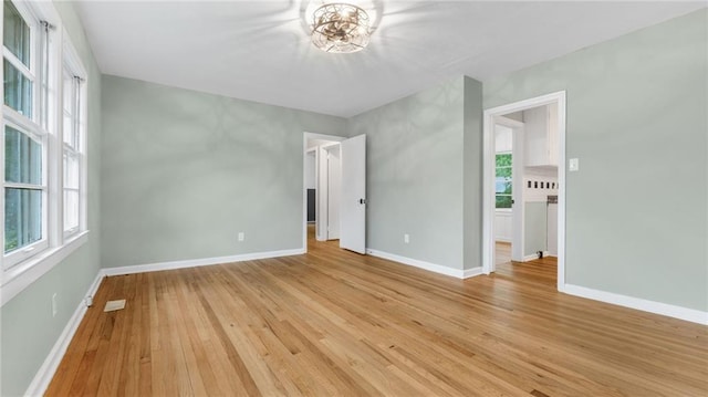 unfurnished bedroom with light wood-type flooring and baseboards