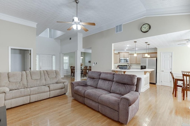 6485 Flowery Way, Flowery Branch, GA 30542 - living area featuring a ceiling fan, crown molding, light wood-type flooring, high vaulted ceiling, and a textured ceiling