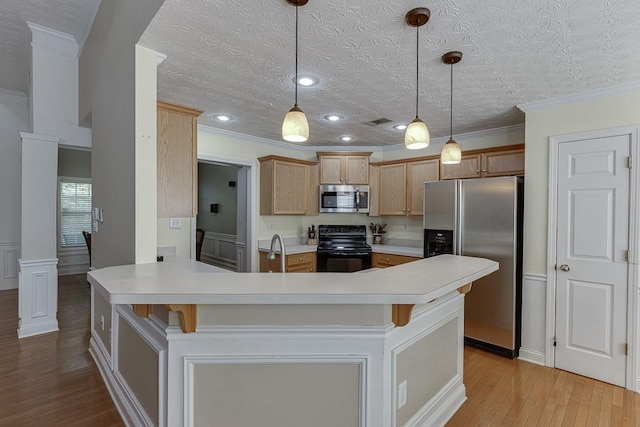 6485 Flowery Way, Flowery Branch, GA 30542 - kitchen with appliances with stainless steel finishes, decorative columns, light wood finished floors, light countertops, and ornamental molding