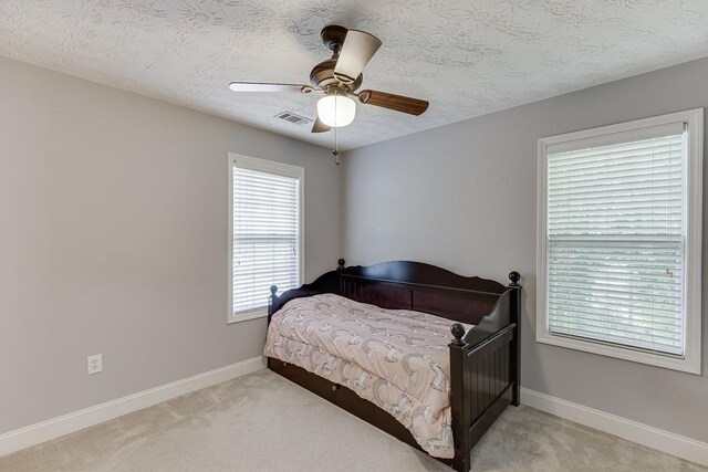 6485 Flowery Way, Flowery Branch, GA 30542 - carpeted bedroom featuring a textured ceiling, baseboards, and a ceiling fan